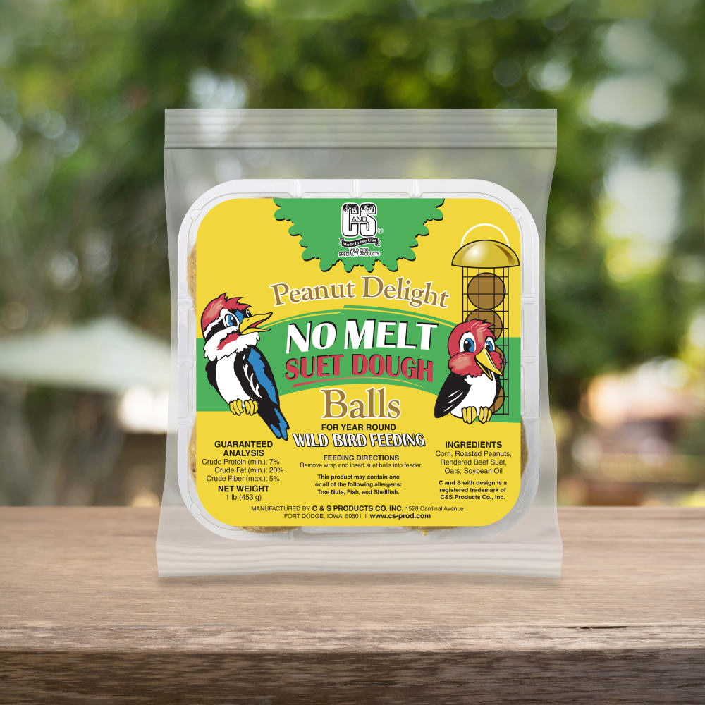 Up close shot of woodpecker delight no melt suet dough sitting on a wooden table